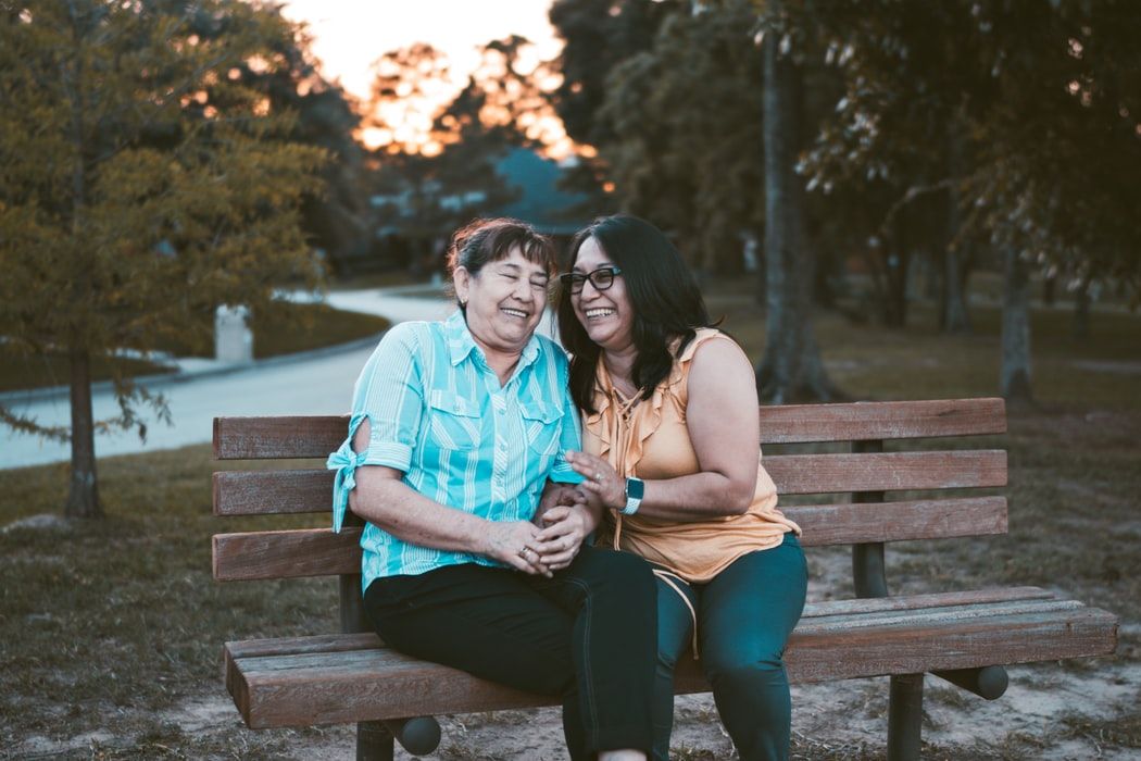 woman smiling on a bench with her mom