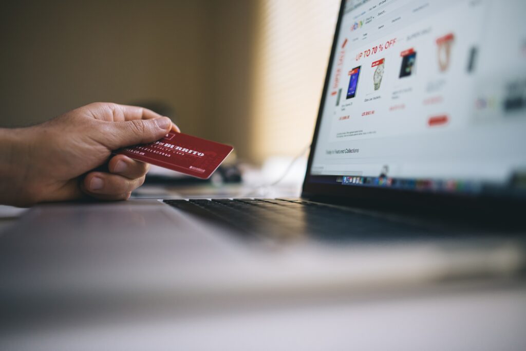 man entering credit card info into computer